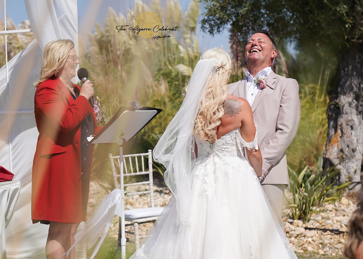 A picturesque outdoor ceremony under the Algarve sun, with Clare and Paul standing hand in hand, surrounded by family and friends in a stunning venue filled with love and joy.