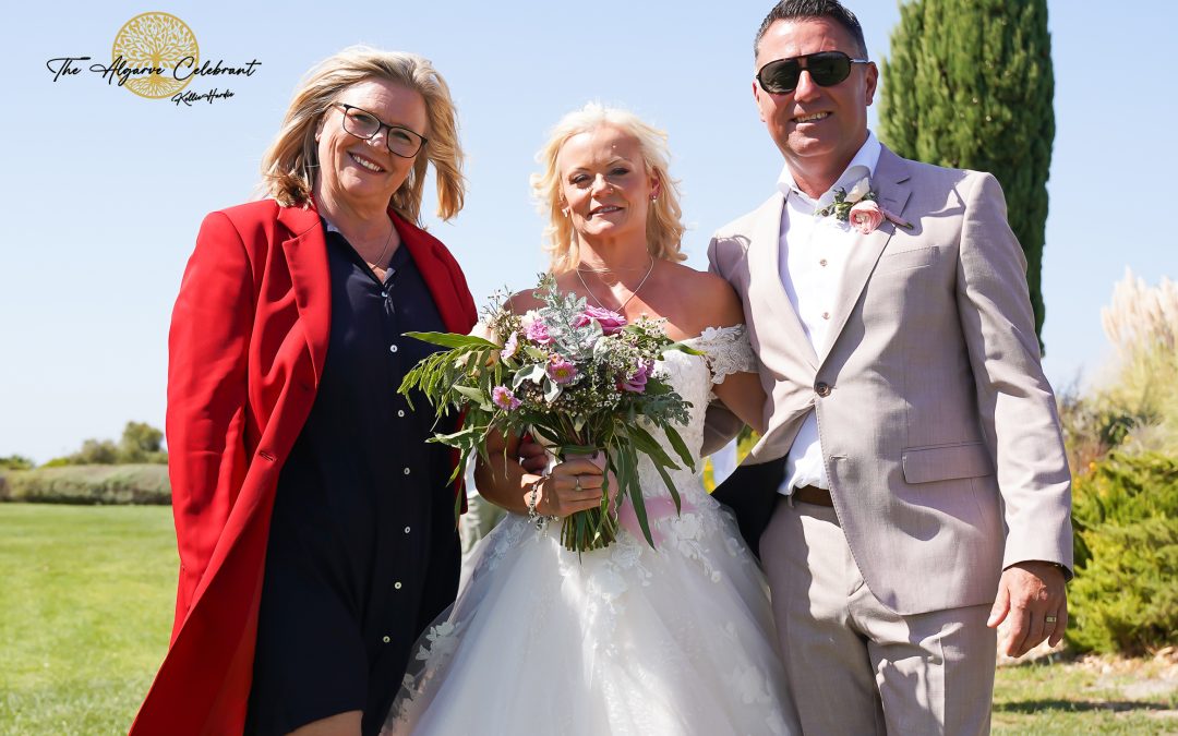 A picturesque outdoor ceremony under the Algarve sun, with Clare and Paul standing hand in hand, surrounded by family and friends in a stunning venue filled with love and joy.