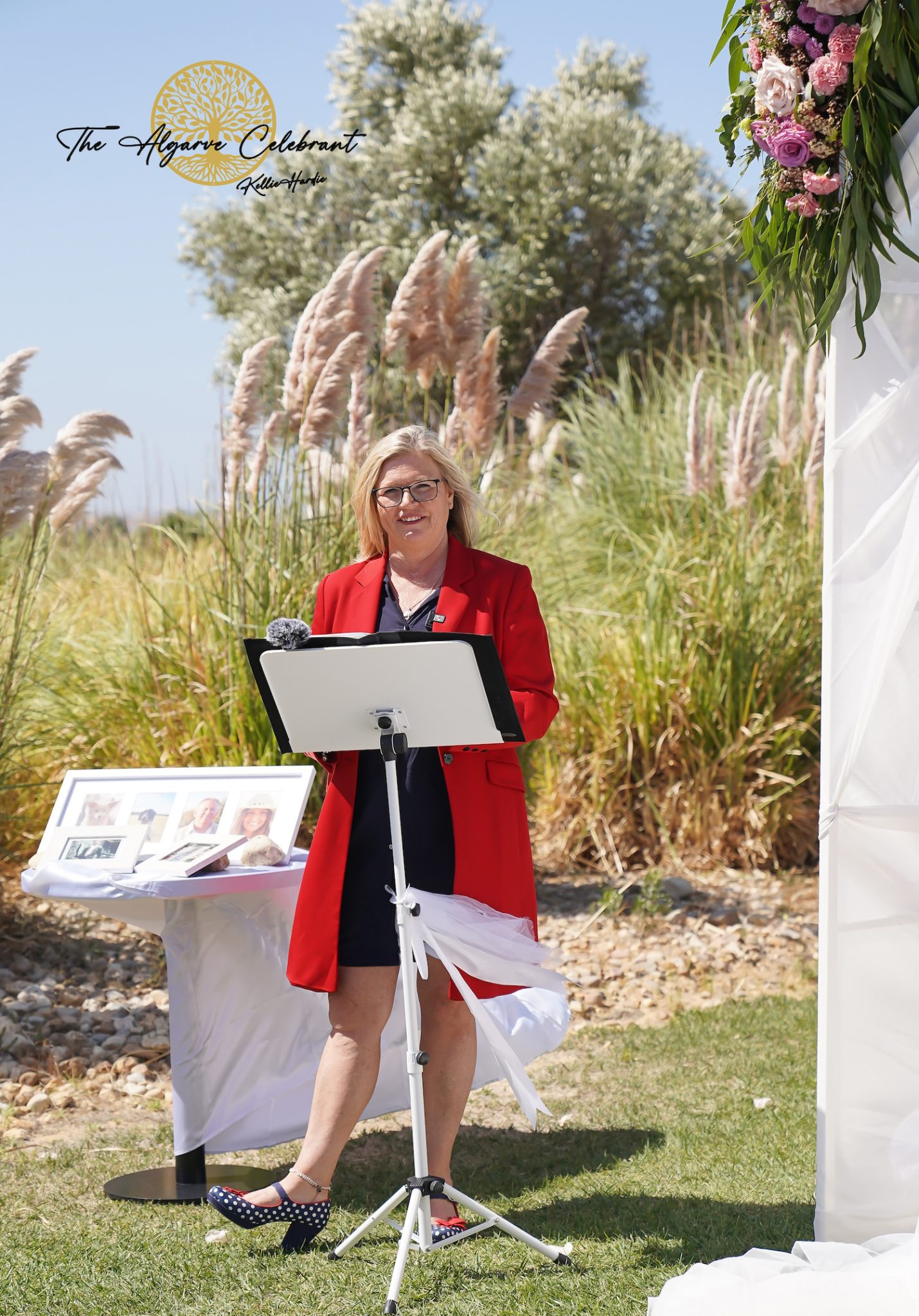 A picturesque outdoor ceremony under the Algarve sun, with Clare and Paul standing hand in hand, surrounded by family and friends in a stunning venue filled with love and joy.