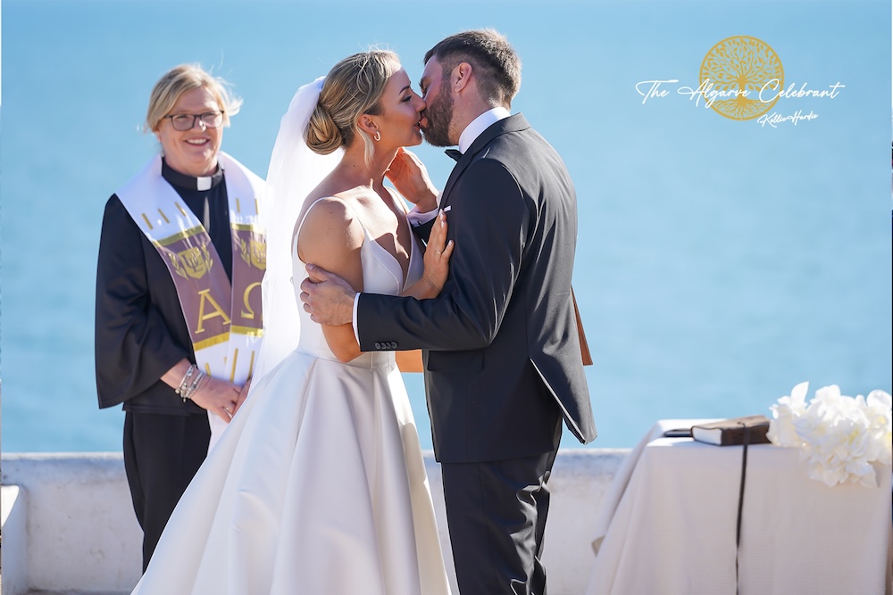 The First Kiss: Daniel and Magdalena sharing their first kiss as husband and wife inside the Senhora da Rocha chapel, framed by its beautiful white interior.